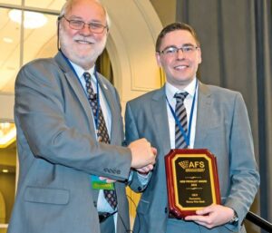 Dominik Herper Accepts Award